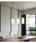 Marble Pendant Light E27 Home Modern Minimalist Decorative Lamps 3 Head Adjustable Hanging Lamp over dining table in a modern room.