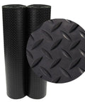 Two black rolls of Diamond Plate Rubber Flooring Roll 3 Mm Thick 4 Ft By 3 Ft Black Heavy Duty Floor Mat For Garage And Workshop Anti Slip Outdoor Surface Protector, with close-up of texture.