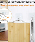 Two clear Heavy Duty Adhesive Hooks Up To 15 Lbs With 180 Degree Rotating Design holding kitchen utensils on a wall.