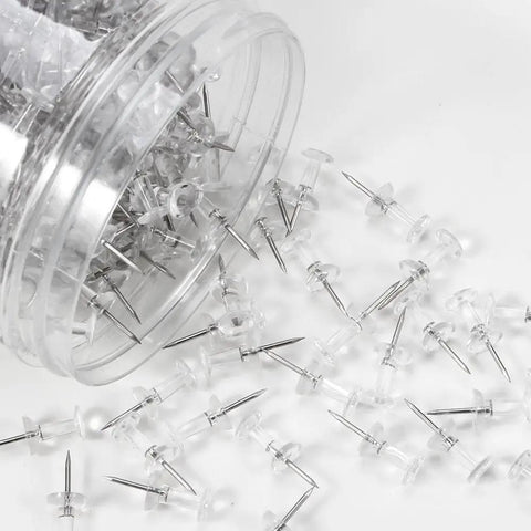 Legit Durable Push Pins 600 Count Standard Thumb Tacks With Kickass Steel Points and Clear Rounded Tops spilled from jar.