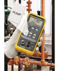 Slick One Hand Electric Pressure Calibrator in use, portable design, checks pressure readings up to thirty PSI, durable for industrial techs.