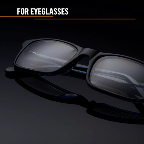 Side view of black plastic eyeglasses with clear lenses on a dark surface
