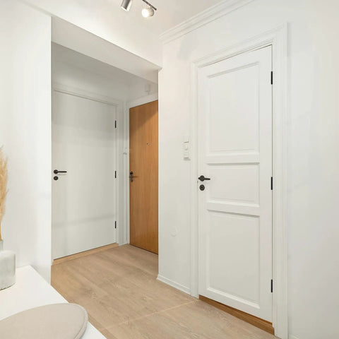 Interior view of a hallway featuring two white doors with Bombproof Heavy Duty Ball Bearing Door Hinges In Matte Black Finish.