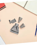 High Grade Stainless Steel Heat Gun Nozzle Set For Plastic Welding And Shrink Wrap Repair With Easy Swap Design and Energy Efficient Airflow laid out on a desk.
