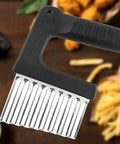 Close-up of Kakalote crinkle cutter with black handle and stainless steel blade