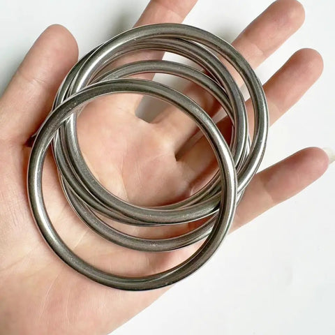 Stainless Steel O Rings 2.7 Inch Welded Closed Seamless Ring 5 Pack Heavy Duty 5mm Wire in hand, smooth mirror finish