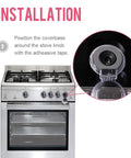 Installation of Clear 6 Pack Stove Gas Knob Covers For Kids Safety on a silver stove, showing adhesive application around knob.