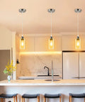 Three pack industrial pendant lights for kitchen island and living areas with clear glass shades and brushed nickel finish.
