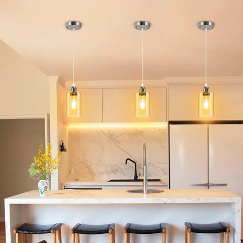 Three pack industrial pendant lights for kitchen island and living areas with clear glass shades and brushed nickel finish.