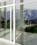 Very Light Window Film With High Heat Rejection And UV Cut 36 Inch By 14 Foot Roll Durable Scratch Resistant Tint That Lets In Light Blocks 99 Percent Of UV Rays installed on a large window, allowing light inside while blocking UV rays.