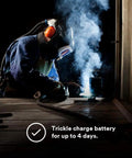 Welder using Smart Lithium Ion Battery Charger for Adflo PAPR Welding Rig with Speedglas Helmets in dim workspace, 35-0099-08 Pro
