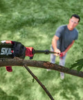 Solid Build Cordless Pole Saw With Eight Inch Bar And Ten Foot Reach To Clear High Limbs Like A Pro cutting through tree branches.