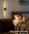 Modern Cordless Wall Sconces Set Of 2 With Remote And Touch Dimming Rechargeable Battery Operated Led Lights For Bedroom Hallway 3000k To 6000k Sleek Black Metal bedside black wall sconce with warm lighting beside sleeping person.