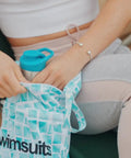 Person holding Two Pack Ultra Waterproof Wet Dry Bags With Dual Zippered Pockets Reusable Diaper Travel Beach Pool Daycare Soiled Items