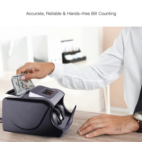 Person using fast money counter machine with UV MG IR counterfeit detection on a desk, front-facing LED display visible.