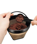 Hands scooping coffee grounds into Gold Tone Permanent Coffee Filter For 12 Cup Coffee Makers Including Krups Savoy Braun DeLonghi