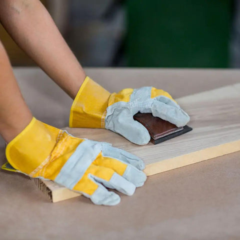 Person using 320 Grit Sandpaper Pro Grade 9 By 11 Inches Pack Of 30 Sheets Silicon Carbide on wood surface for sanding