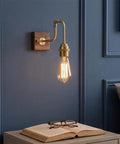 Vintage Brass Wall Sconce, Industrial Wood Light Fixture with adjustable arm on walnut base next to open book and glasses.