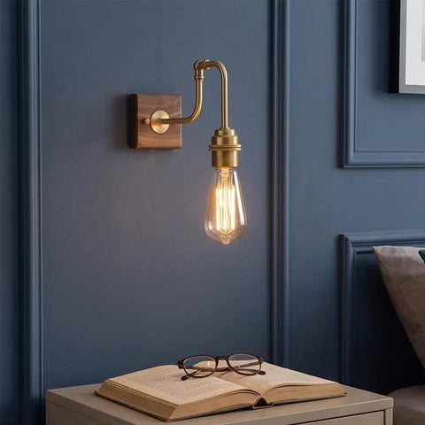 Vintage Brass Wall Sconce, Industrial Wood Light Fixture with adjustable arm on walnut base next to open book and glasses.