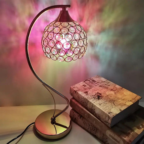 Colorful stained glass lamp next to stacked books on a table