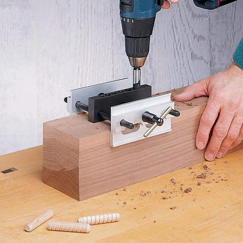 Wide Capacity Self Centering Doweling Jig for Woodworking on a wooden block, drill positioned in heavy duty aluminum frame guide