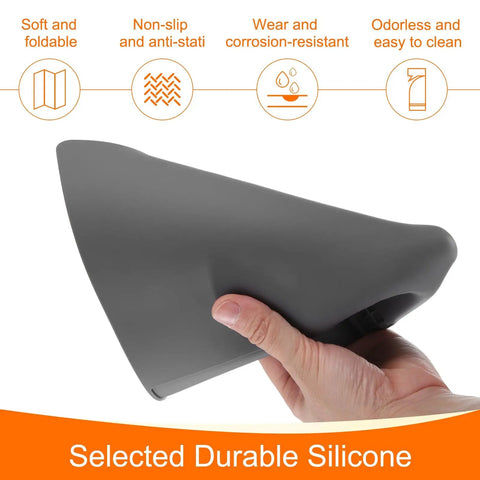 Hand holding a gray Anti Static Foldable Non Slip Premium Flexible Silicone Soldering Mat 15 Point 8 By 11 Point 8 Inches.