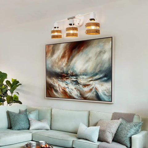 Contemporary 3 Light Vanity Wall Sconce With Wood Lampshade In Matte White And Brushed Nickel Accent above painting in living room.