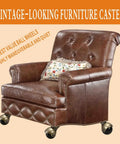 Vintage 2 Inch Ball Caster Wheels For Furniture Antique Brass Swivel Plate Castors on a brown leather armchair.