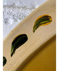 Close-up of leaf detail on Hand Painted Strawberry Lazy Susan 19.5 Inch for Farmhouse Kitchen Decor and Organization.