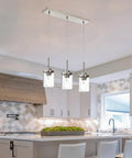 Black Island Pendant Lighting 5 Light Farmhouse Rectangle Linear Chandeliers With Clear Glass Shades in a kitchen setting.