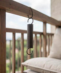 Heavy Duty Two Pack Hook Extension Springs For Recliner Chair Repair Solid Black Steel hanging from a wooden railing outdoors.