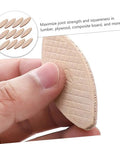 Close-up of hand holding a piece from 100 Pcs Beech Wood Biscuits Set For Woodworking