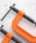 2 Inch C Clamp Set, Four Heavy Duty Steel C Clamps For Woodworking, Welding, And Building Projects, Industrial Strength With Anti Rust Finish, Non Slip Screws, 1 Inch Throat, Durable Orange Finish For A Reliable Grip. Orange steel C clamp close-up