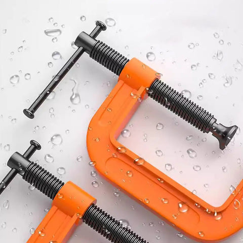 2 Inch C Clamp Set, Four Heavy Duty Steel C Clamps For Woodworking, Welding, And Building Projects, Industrial Strength With Anti Rust Finish, Non Slip Screws, 1 Inch Throat, Durable Orange Finish For A Reliable Grip. Orange steel C clamp close-up