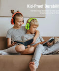 Kids wearing Kids Noise Canceling Ear Muffs 27.4dB 2 Pack Adjustable Hearing Protection For Toddlers And Teens Age 3 To 16 reading on sofa