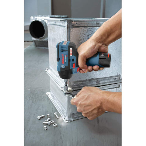 Person using 12V Max Brushless Three Eighths Inch Impact Wrench Bare Tool Ultra Compact Five Point Five Inch Head Lightweight One Point Six Pound Tool Only Cranks Out Up To Eighty Five Foot Pounds Of Torque No Load Speeds 0 To 1200 And 0 To 2600 RPM on metal duct