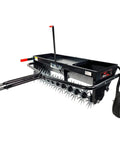 Tow Behind 2-In-1 Lawn Aerator And Spreader With Weight Tray For Extra Penetration Drops Seed Fertilizer Or Lime While Aerating 40-Inch Wide Flat Black, shown in a side angle with spiked rollers.