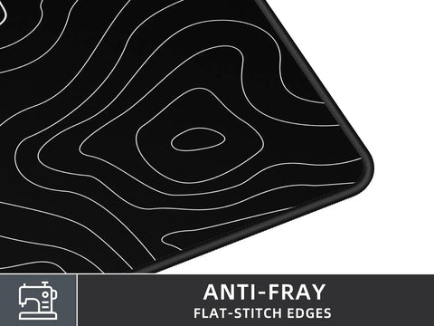 Close-up of Extra Large Gaming Mouse Pad With Black Topographic Print XXL Desk Mat For Gaming And Work showing corner detail with anti-fray edges.