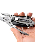 Hand holding Two Piece Portable Stainless Steel Multitool Pliers Set with Wire Cutters and Multi Purpose Wrench for outdoor survival.