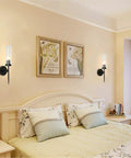 Mid Century Modern Black Wall Sconce Set Of Two 1 Light Clear Cylinder Glass on bedroom wall above bed