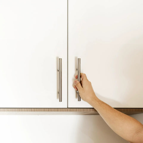 Person opening cabinet with 4 Inch Satin Nickel Truss Bar Cabinet Pulls 10 Pack Center To Center 104 mm