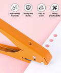 Heavy Duty Single Hole Punch Plier Tool With Five Sixteenth Inch And Three Eighth Inch Holes punching paper on pink surface