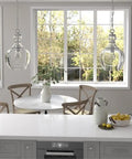 11-Inch Wide Pendant Light With Glass Shade In Brushed Nickel And Clear Finish above kitchen island in modern dining room