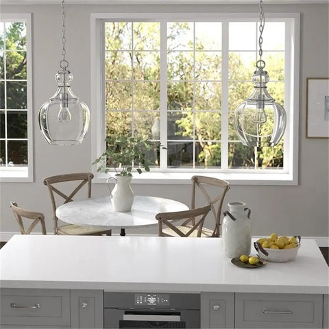 11-Inch Wide Pendant Light With Glass Shade In Brushed Nickel And Clear Finish above kitchen island in modern dining room