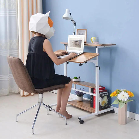 Height Adjustable Overbed Table With Smooth Rolling Casters, Sit To Stand Laptop Desk, Ergonomic Steel Frame Cart For Bed Or Couch in use with a person typing.
