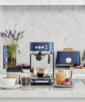 Damson Blue Kickass Espresso Coffee Maker Featuring Auto Milk Frother Quick Heat Technology And Reliable Pressure Pumping For Next Level Barista Quality Home Brews Any Day in modern kitchen setting.