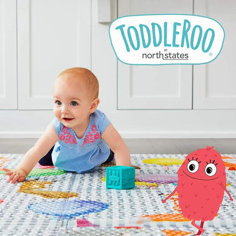 Toddler playing on a colorful mat near a red cartoon character,  under "Toddleroo by Northstates" logo.