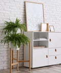 White cabinet with Six Piece Leather Drawer Pulls Set In Brown With Gold Rivet Screws, 4.72 Inch Soft Handles, near a plant.