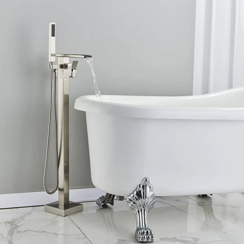 Top Notch Freestanding Bathtub Faucet Floor Mount Tub Filler with Waterfall High Flow Spout and Shower Mixer Faucet Brushed Nickel Brass Construction with Hand Shower next to a clawfoot bathtub.