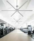 No Sweat 120 Inch HVLS Ceiling Fan For Shops And Gyms in a bright gym, featuring aluminum blades and smooth design.